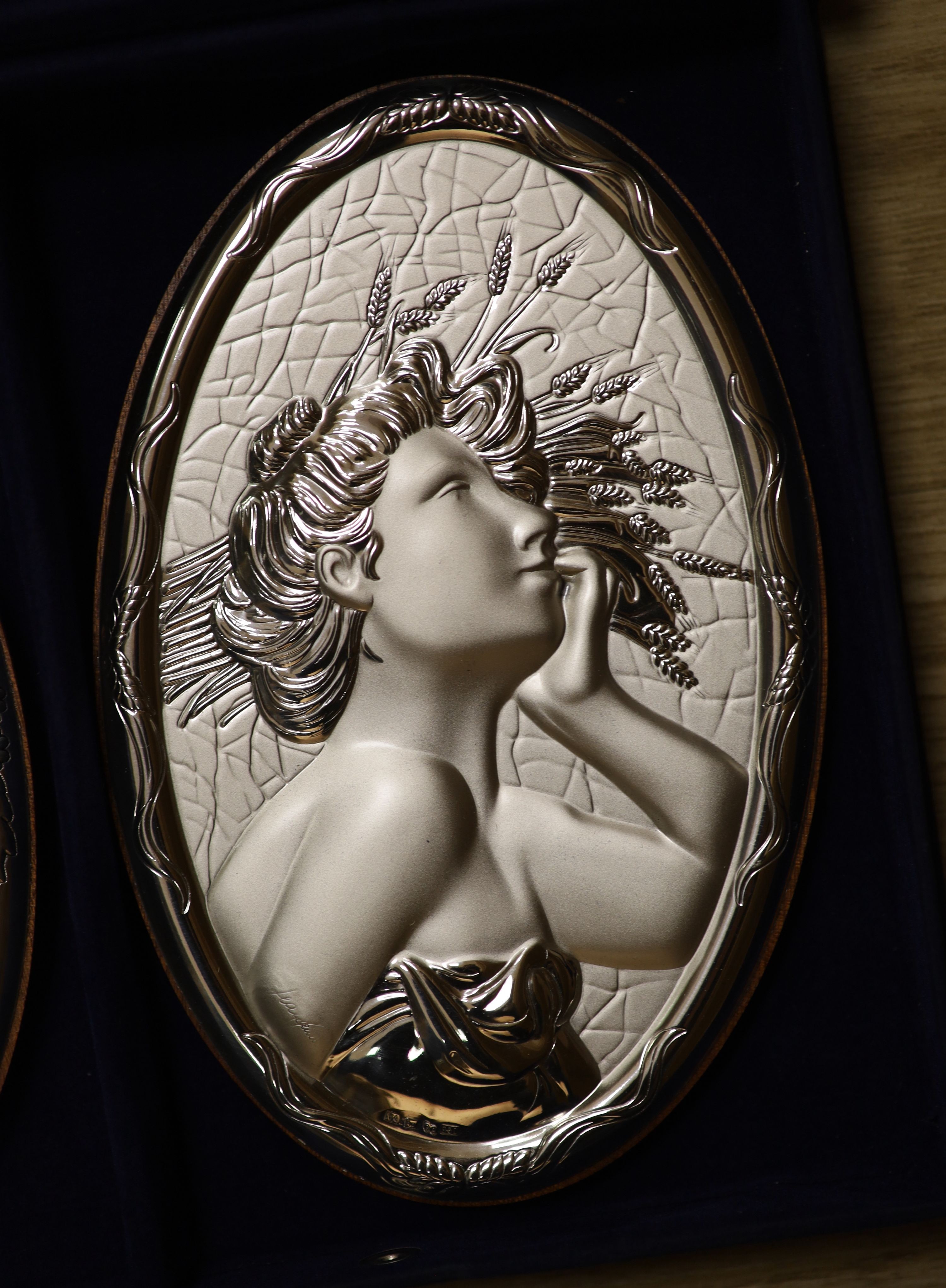 A cased set of four modern Italian repousse 850 white metal mounted 'The Four Seasons' wall plaques, 20.4cm.